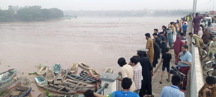 People watch from Shahdara-Lahore Bridge as water level in Ravi begins to recede. WE Punjab Photo