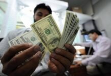 Image shows a man counts money. File