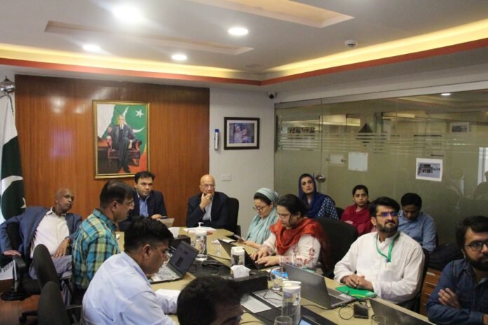 The image shows EOC coordination chairing a meeting to review arrangements for polio vaccination campaign-EOC