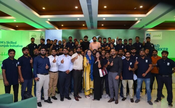 The picture shows PSDF officials and trained youth recently employed as lead workers in Qatar-PSDF