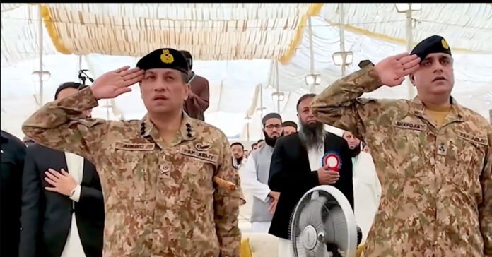 DG ISPR Lt Gen Ahmed Sharif Chaudhry stands in respect as the national anthem is played during his visit to Jamia Tur Rasheed, Karachi.