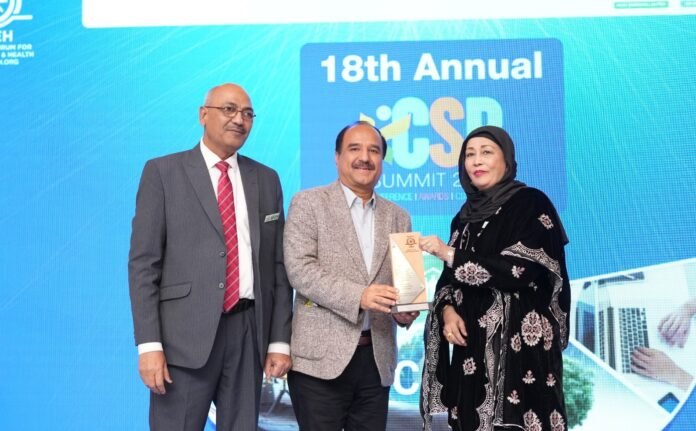 The image shows Thar Foundation official receiving award at a ceremony.